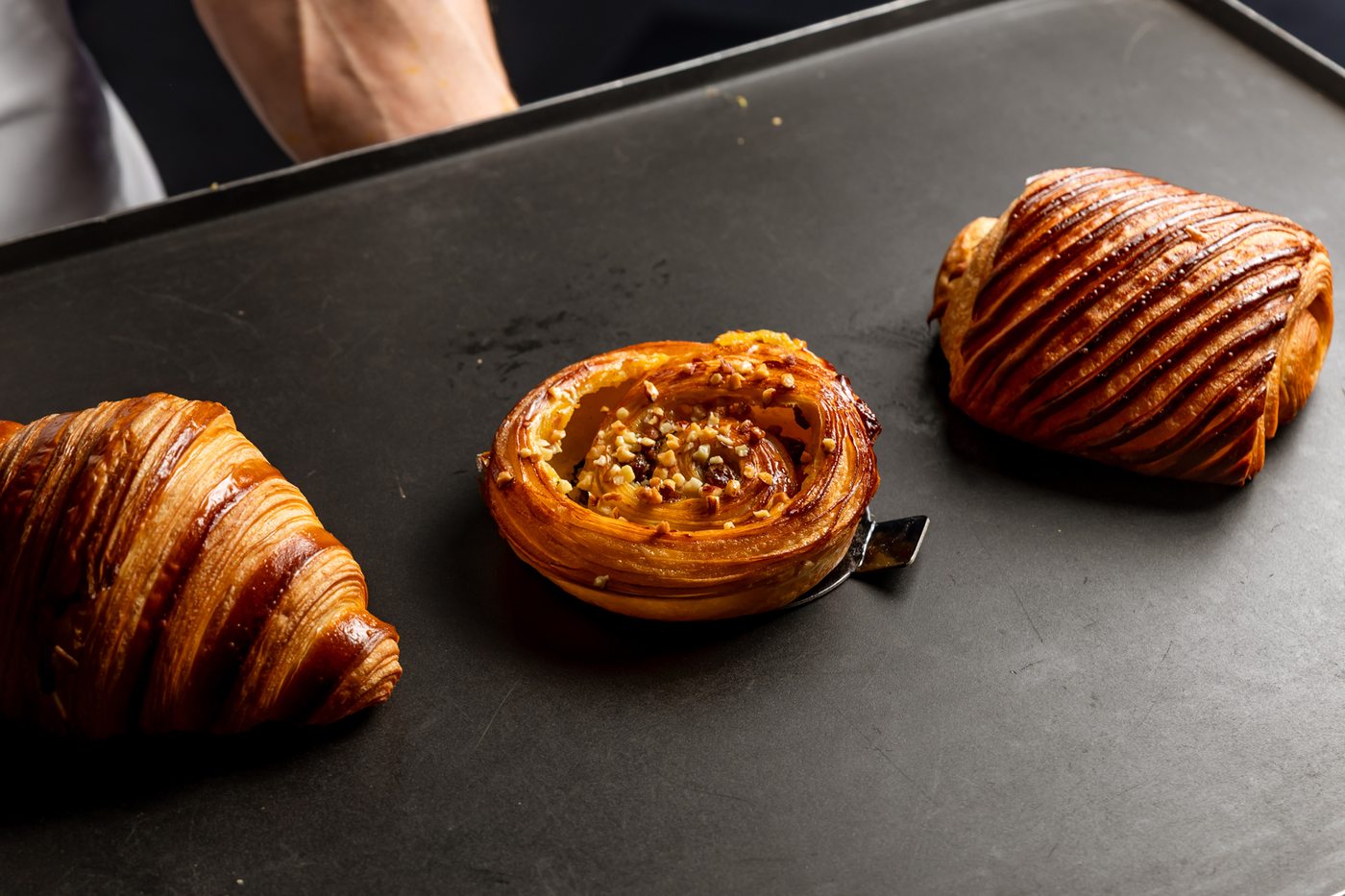 Three pastries on a black tray